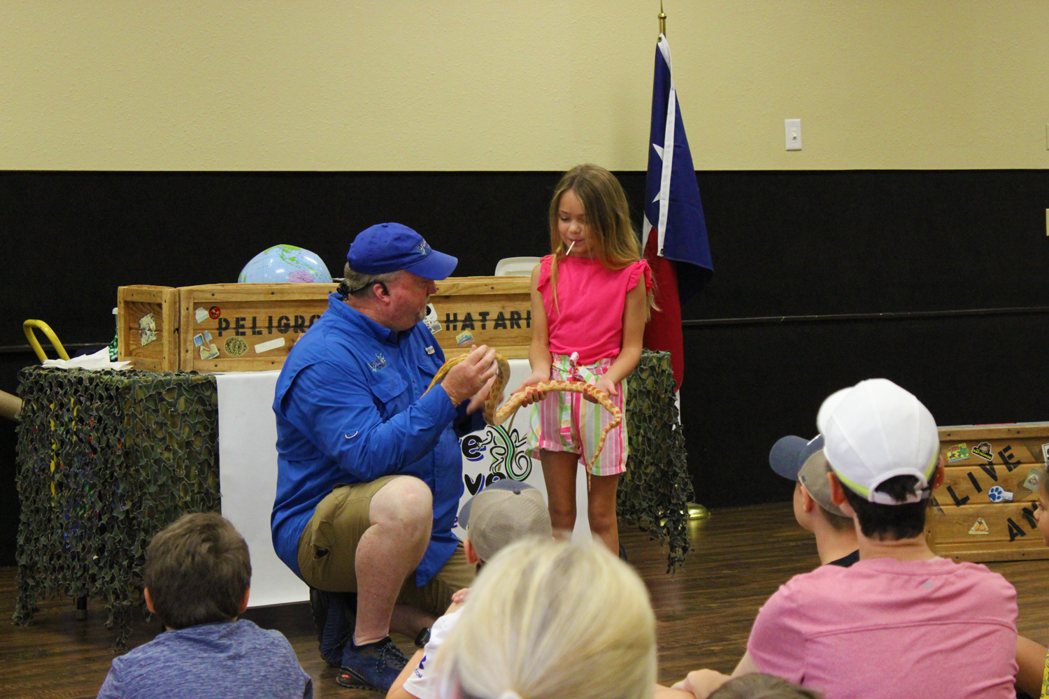 Presenter with snake and young girl holding it